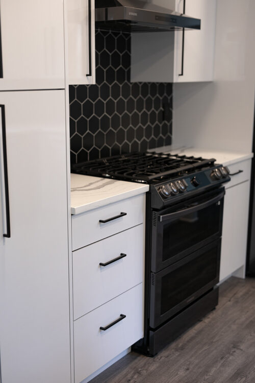 Black Backsplash with White Cabinets